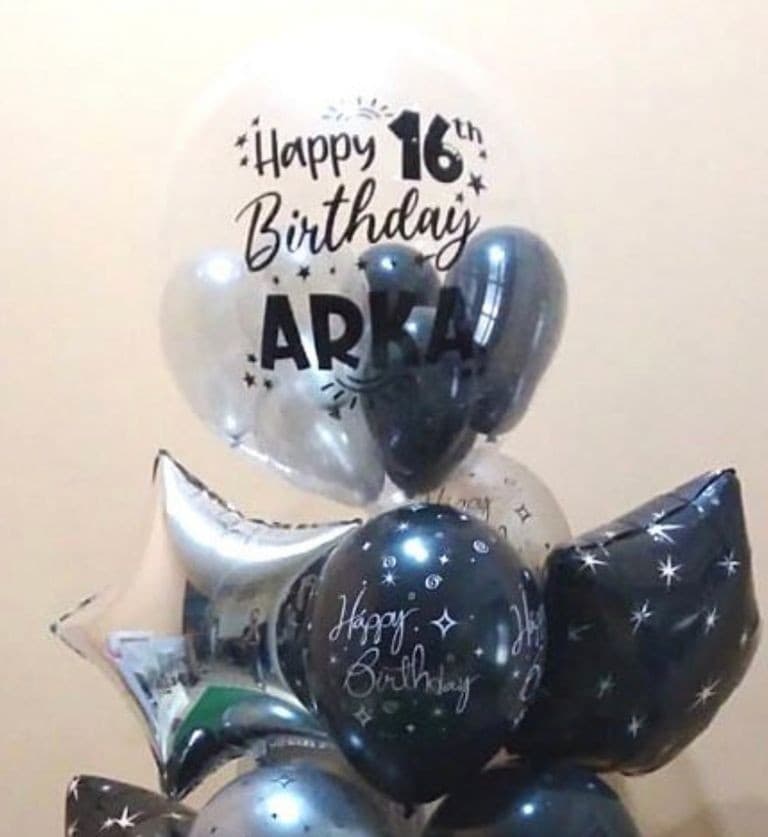 Personalized clear bubble balloon reading Happy 16th Birthday in a bouquet with navy and silver star-print balloons